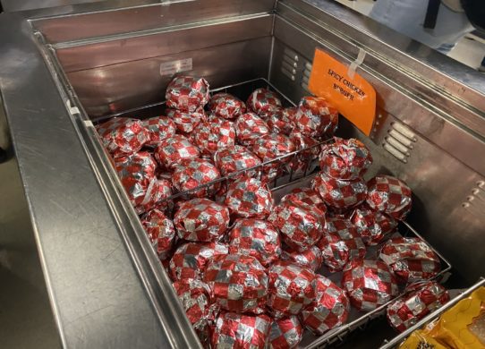 Bin full of the school's wrapped spicy chicken burgers.