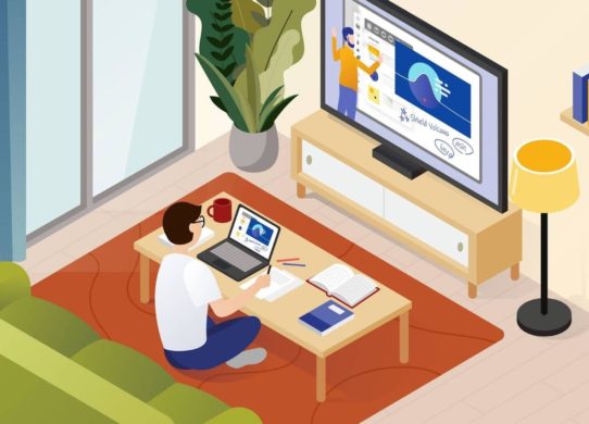 Person sitting in living room on a computer, engaging in distance learning.